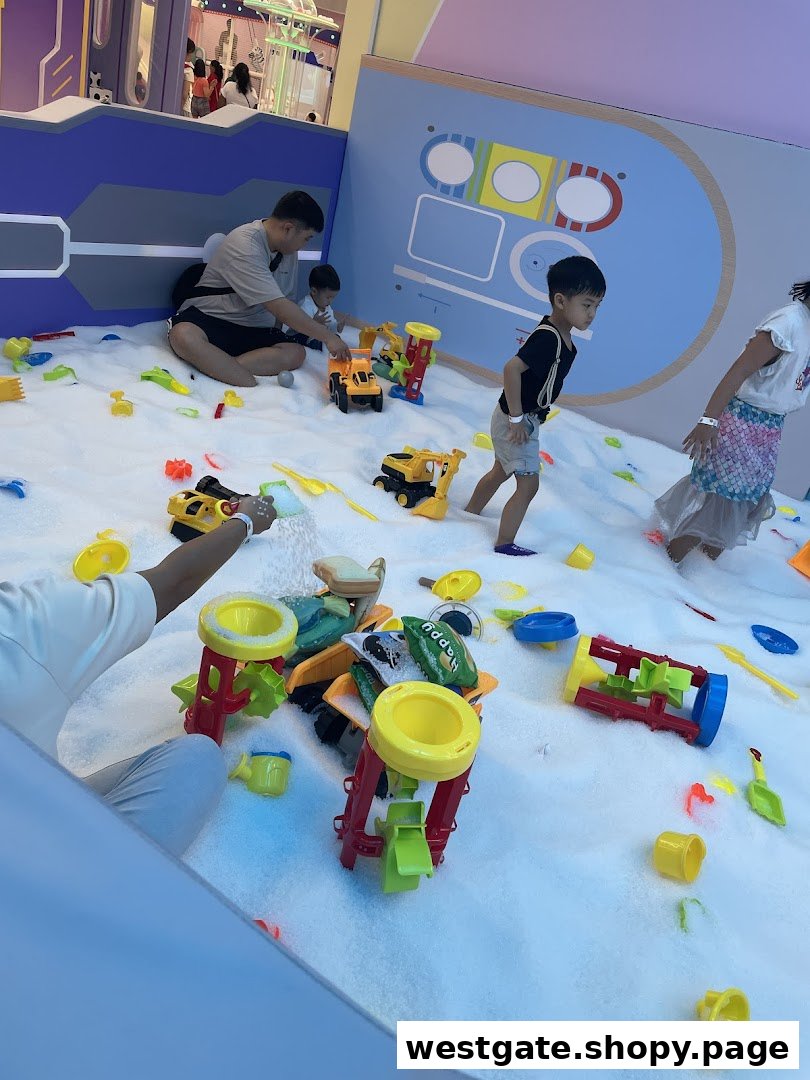 Children and adults play with toys in a white indoor play area at Yooland.