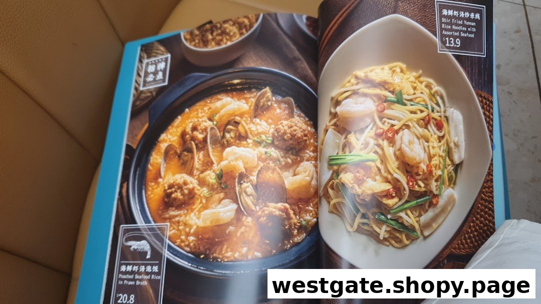 An open menu displaying two seafood dishes: Poached Seafood Rice and Stir Fried Yunnan Rice Noodles.