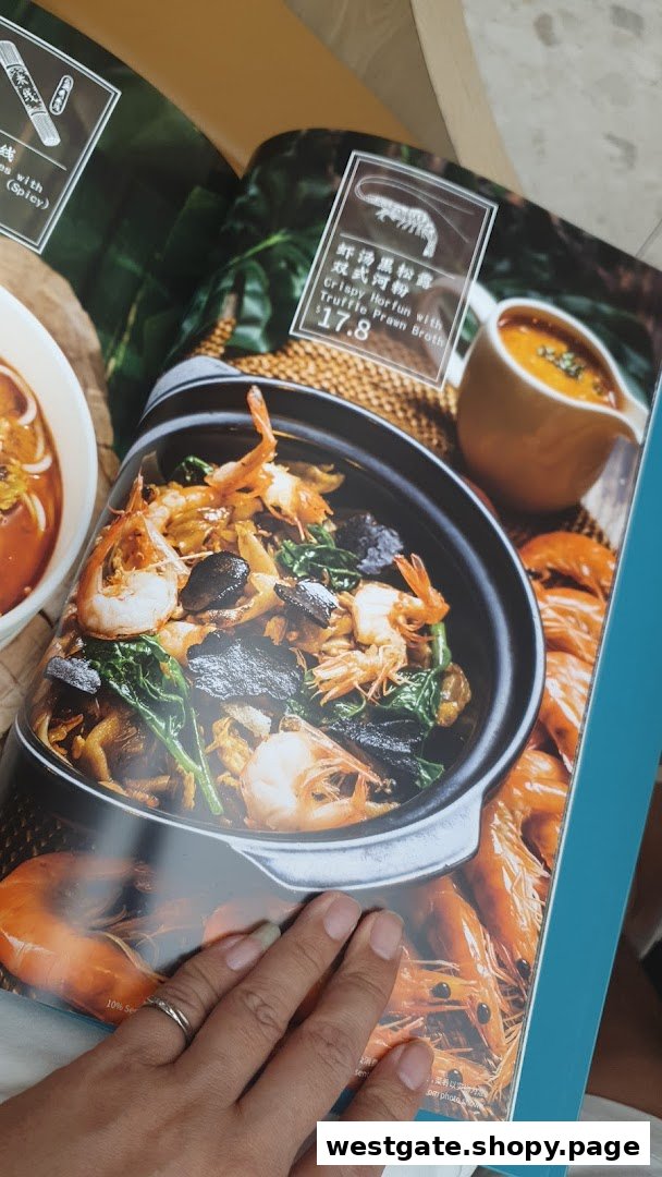 A close-up of a menu page displaying a Crispy Horfun dish with truffle prawn broth.