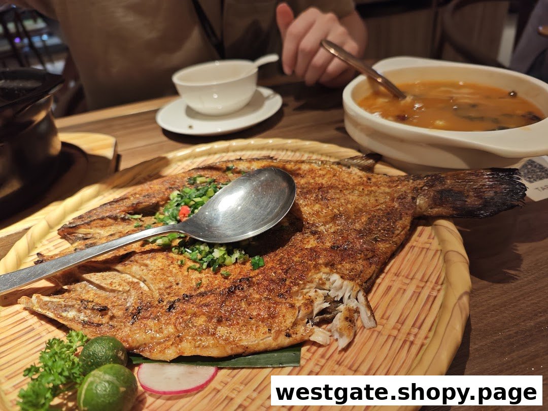 A delicious grilled fish dish with herbs and limes, served alongside a bowl of soup.