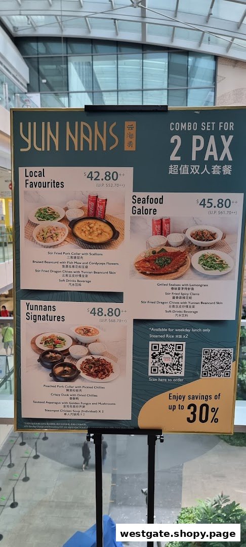 A YUN NANS menu board displaying combo sets for two people with prices and dish details.