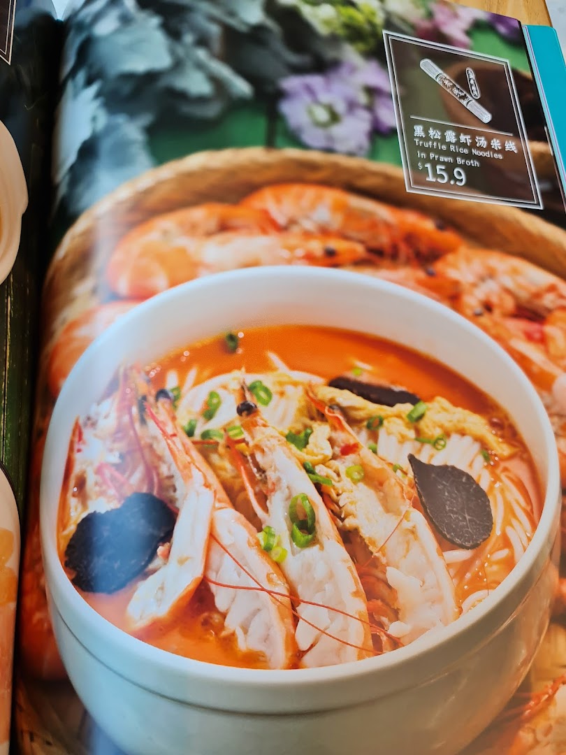 A menu page showcasing a bowl of Truffle Rice Noodles in Prawn Broth with a price of $15.9.