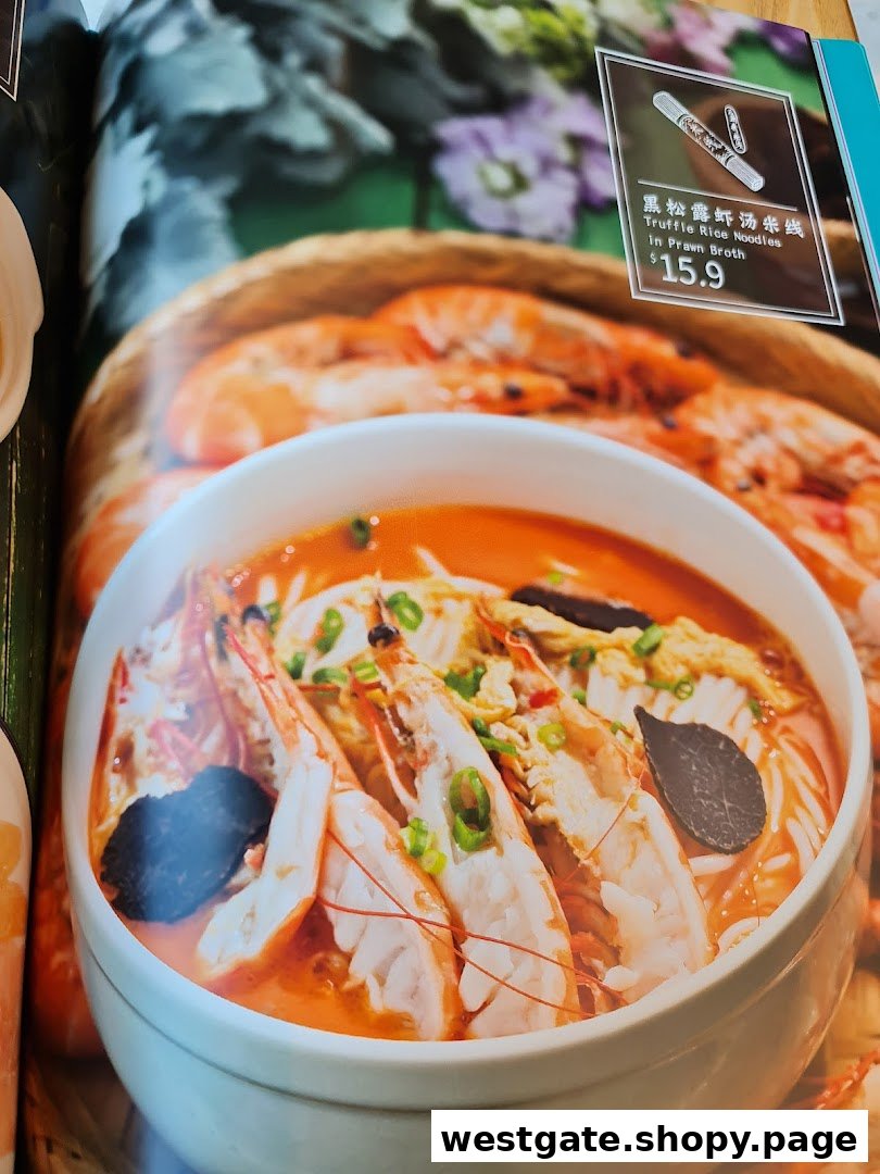 A menu page showcasing a bowl of Truffle Rice Noodles in Prawn Broth with a price of $15.9.