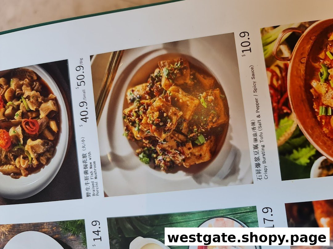 A close-up of YUN NANS restaurant menu, showcasing Braised Fish Maw and Crispy Bursting Tofu dishes with prices.