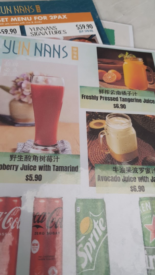 A close-up of YUN NANS' menu, showcasing beverages and set meal prices.